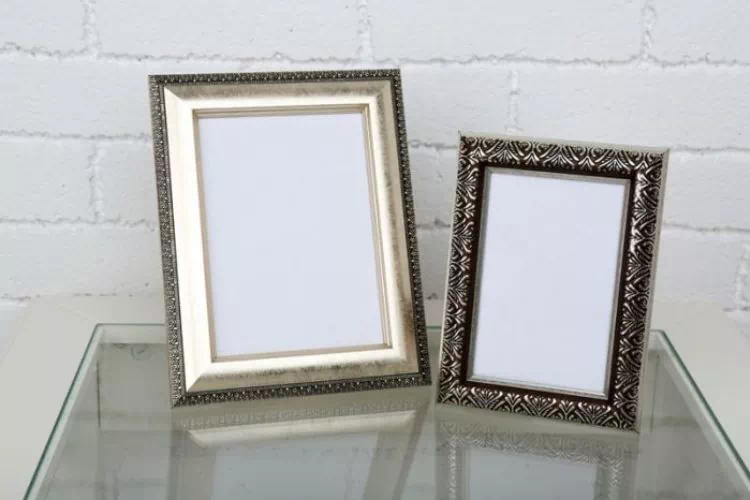 Deux cadres en métal posés sur un support en verre